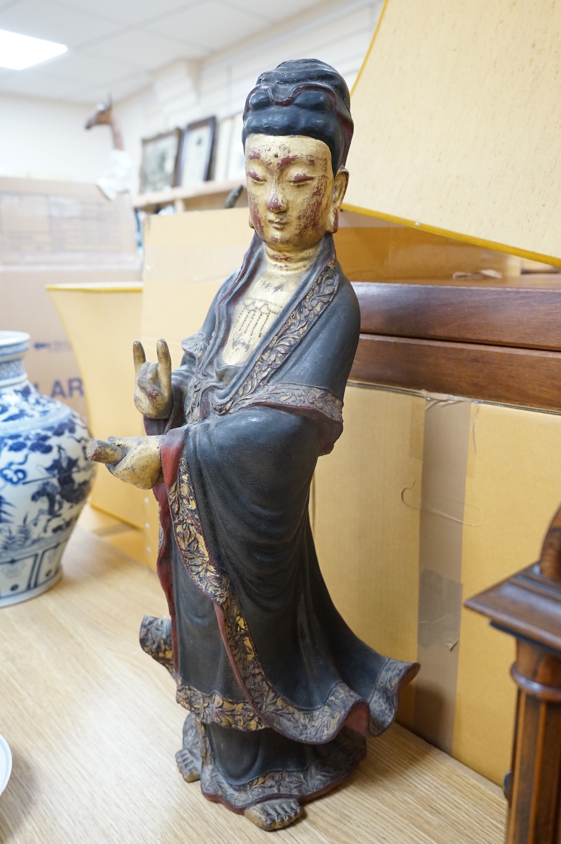 A Chinese partially gilt papier-mâché figure of Guanyin, 63cm high